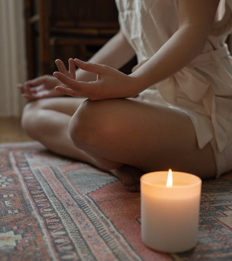 Woman in a peaceful yoga pose, bathed in warm, soft light.